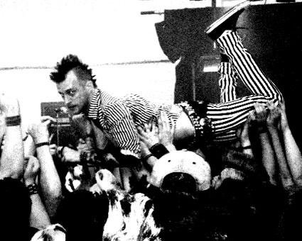 Chris crowd surfing at a punk show