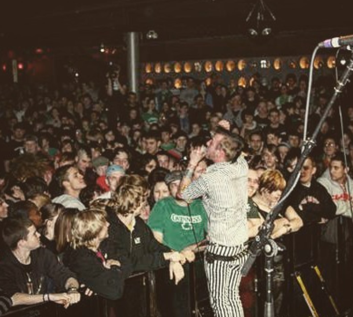 Chris on stage at a packed punk show